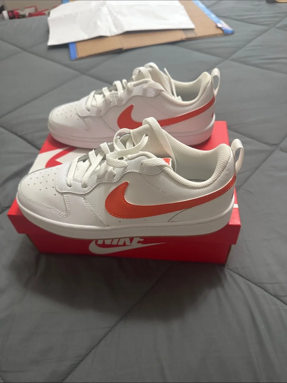 Nike Kids White Sneakers with Orange Swoosh Accent